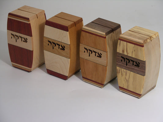 Set of four EC13 tzedakah boxes, left to right: EC13A bloodwood/maple, EC13B maple/cherry, EC13C cherry/cherry, EC13D spalted maple/walnut; arched profile with inlaid hardwood strips.
