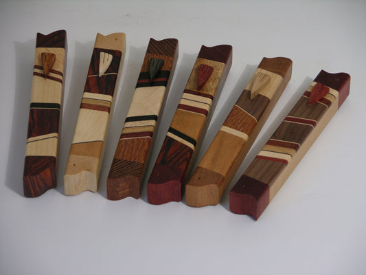EC3A mezuzah case in mixed hardwoods with carved wooden shin; approx. 4.75 inches long.