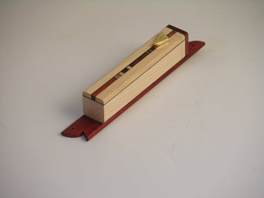 EC6 mezuzah case with 3.875-inch maple body, center strip of assorted hardwoods, and bloodwood accents.